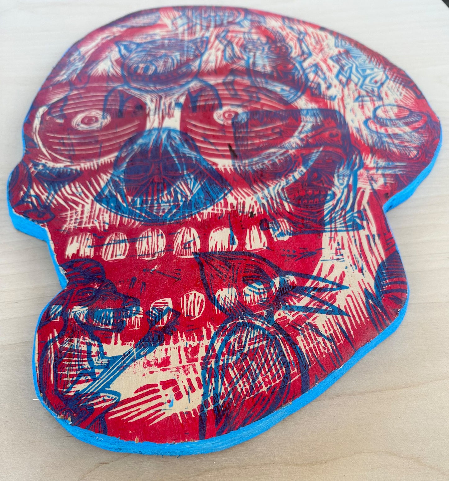 Red and Blue Skull Woodcut Printed on Wooden Panel